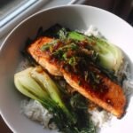 Asian-style glazed salmon bowl with bok choy and rice.
