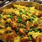 Chicken and vegetable curry with cauliflower and peas.